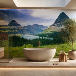 Vadideki yeşil çayırlar, çam ormanı, dağ gölü ve heybetli zirveler manzarası; oval traverten küvet, ahşap tabure ve gizli LED aydınlatmayla banyo alanlarına ferah bir spa atmosferi katar.